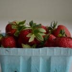 A pint container of fresh strawberries.