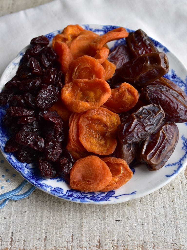 Dried Apricots, dried cherries, and medjool dates on a small plate
