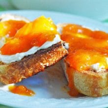 Apricot jam and labneh on a piece of toast.