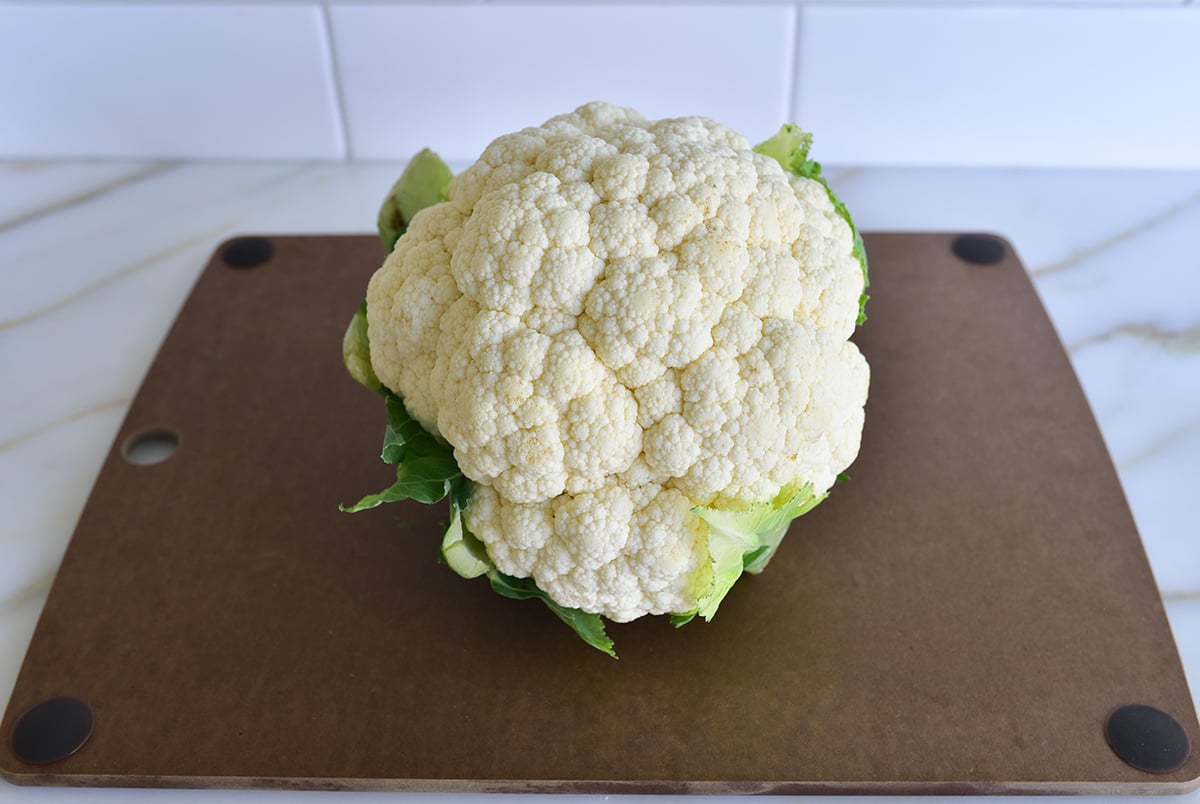 Head of cauliflower on a brown cutting board