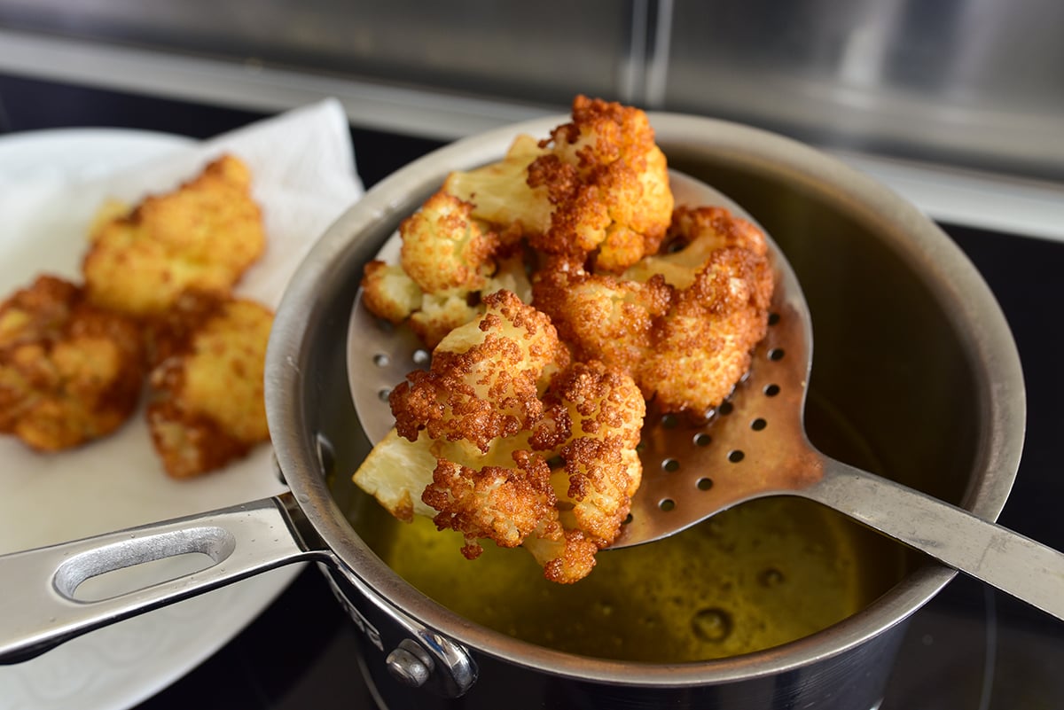 Fried Cauliflower in a slotted spoon