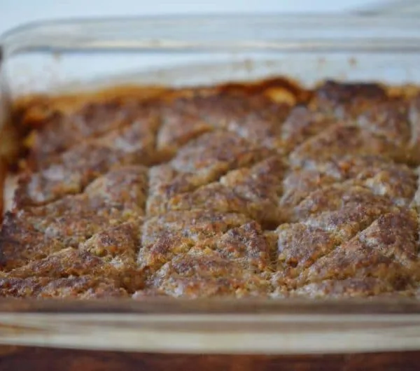 Baked kibbeh in a glass baking dish, cut in decorative squares, Maureen Abood
