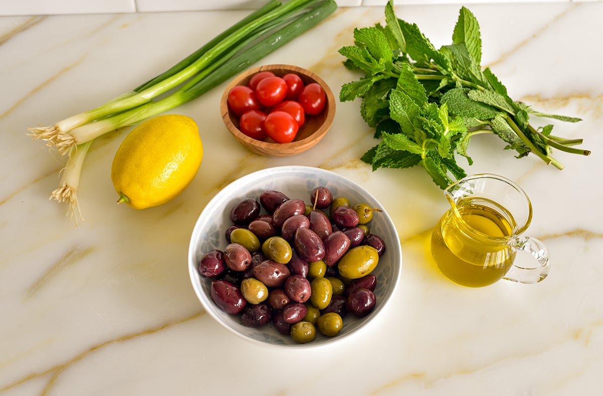 ingredients for olive salad on a marble countertop