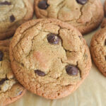 A chocolate chip cookie on parchment paper