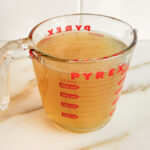 Chicken stock in a pyrex measuring cup