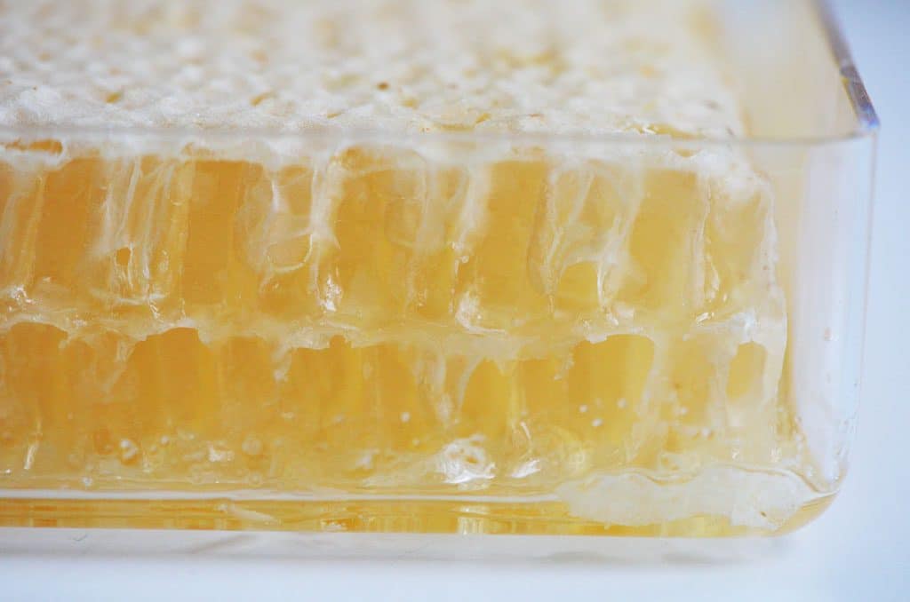 Raw honey comb in a plastic box