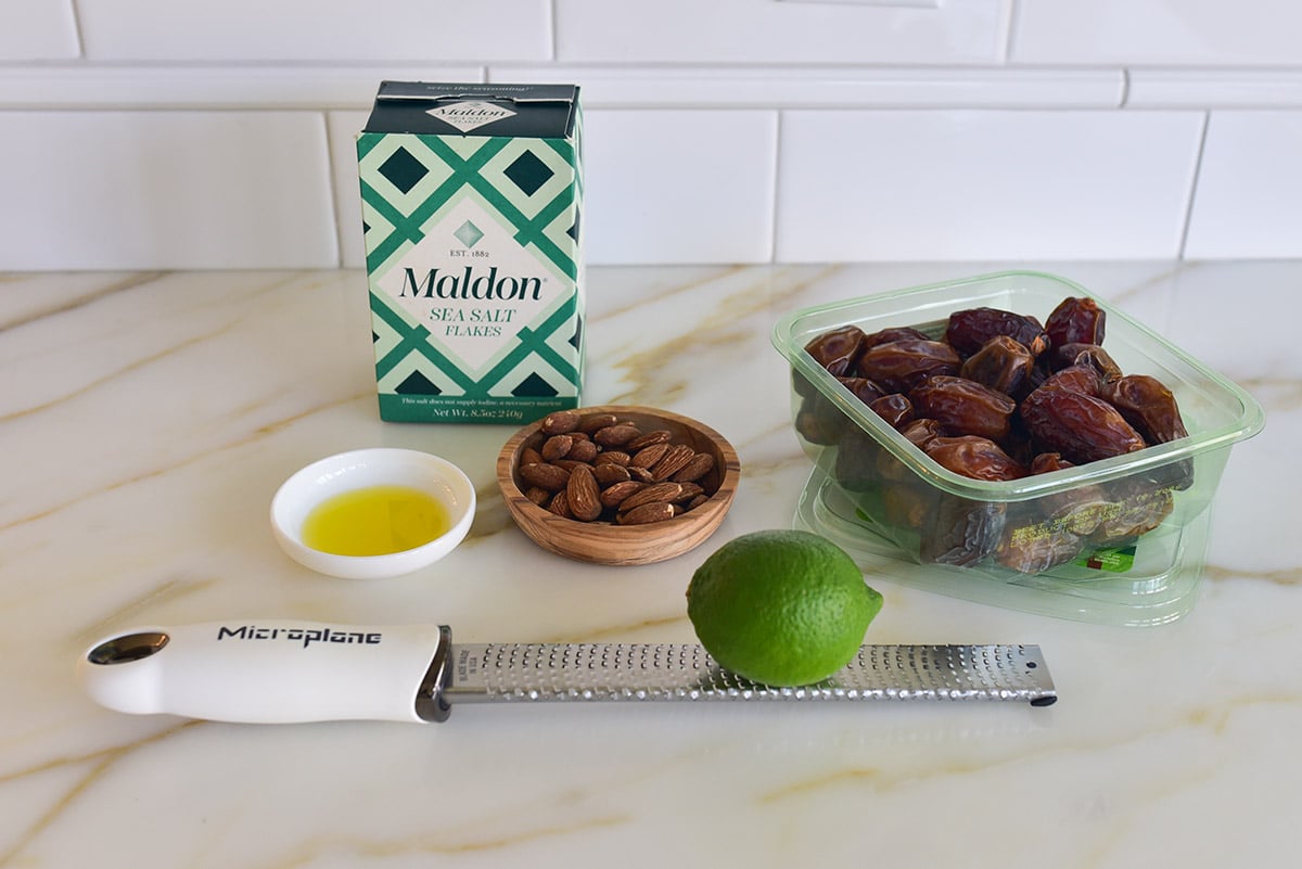 Ingredients for stuffed dates on a marble countertop