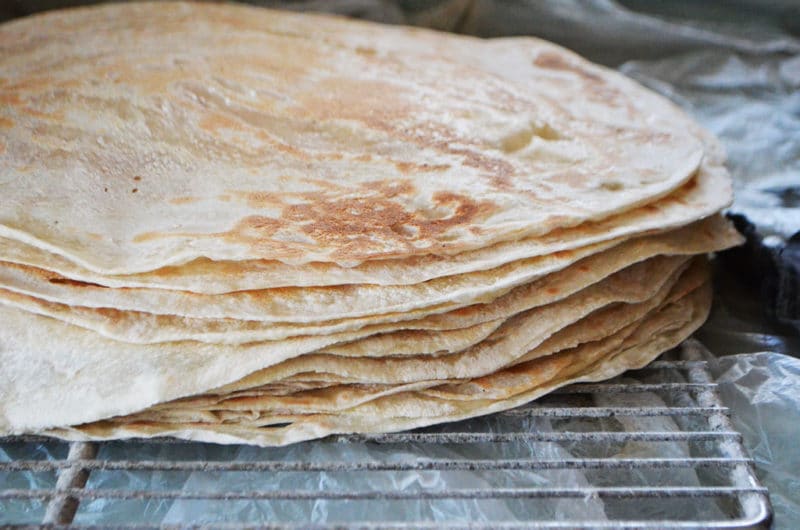 A stack of flatbread on a wire rack.