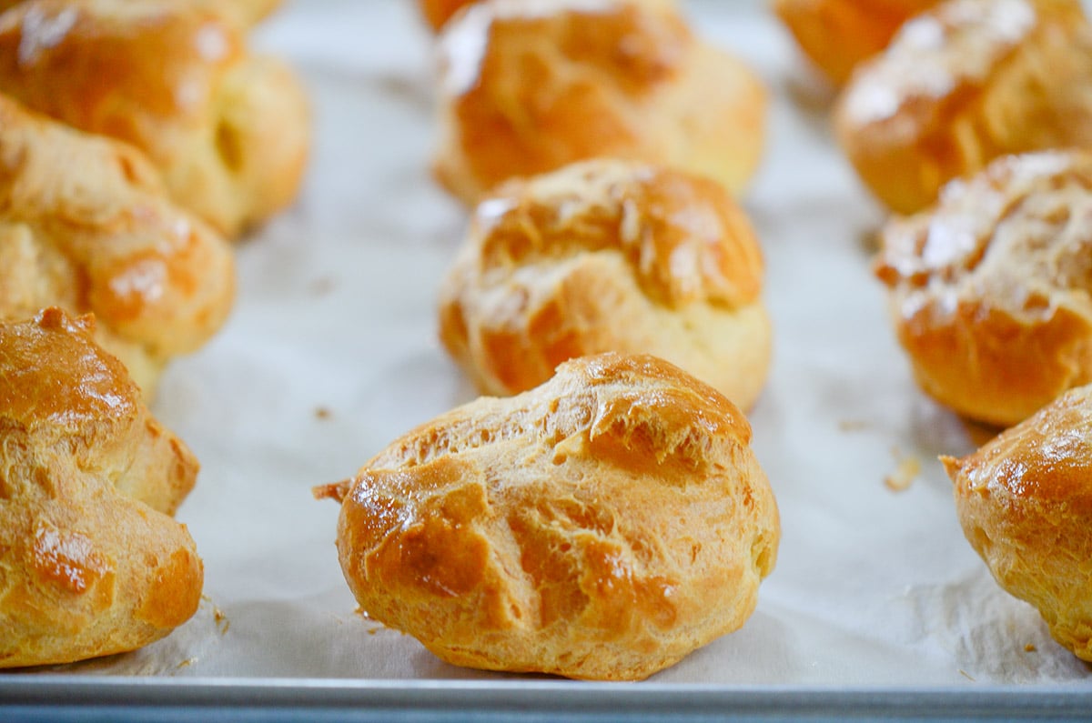 Baked cream puffs on a baking sheet