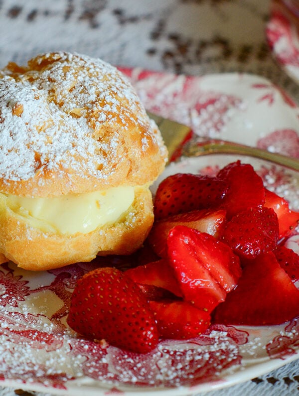 Cream puff on a pink and white plate
