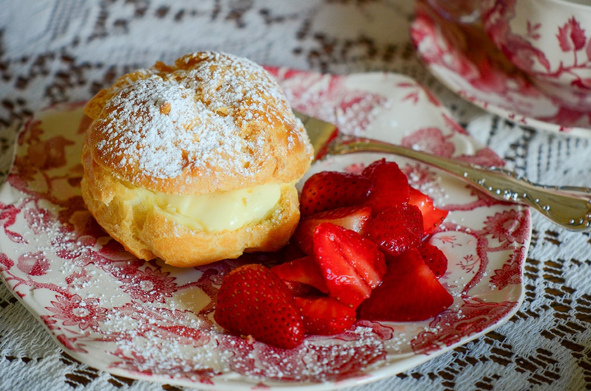 Cream puff on a pink and white plate