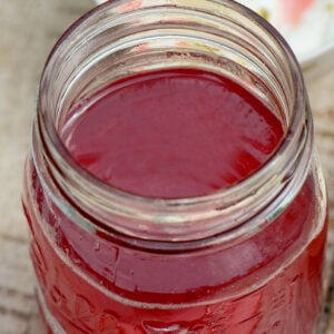 Pink rhubarb syrup in a glass jar