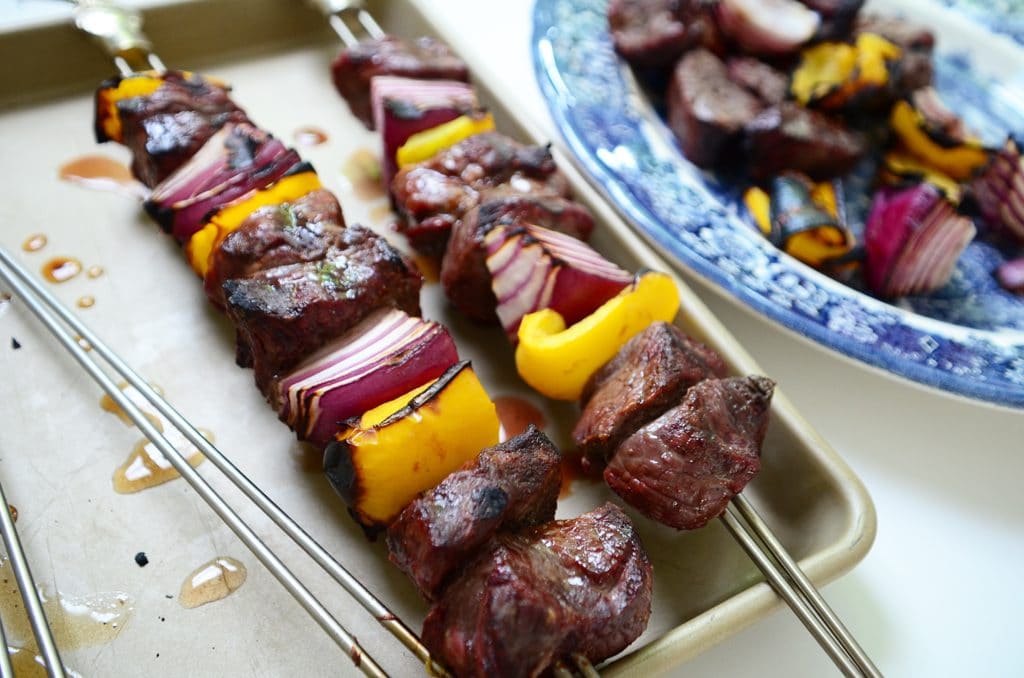 Lamb shish kebabs on a pan with yellow peppers and red onion, Maureen Abood