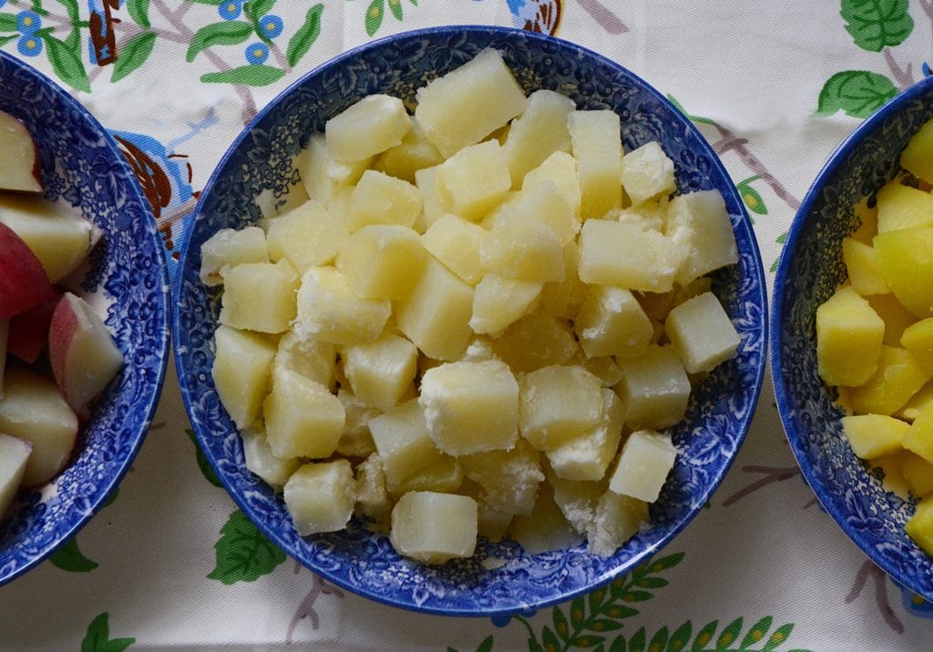 Diced potatoes in a blue bowl 