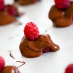 chocolate covered raspberries on wax paper