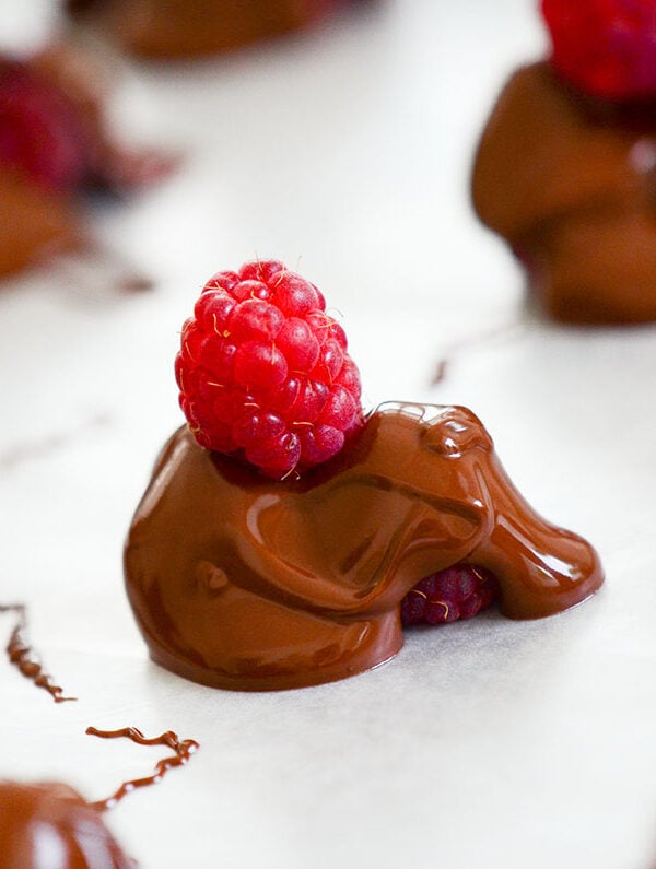 chocolate covered raspberries on wax paper