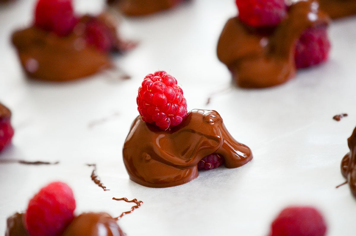 chocolate covered raspberries on wax paper