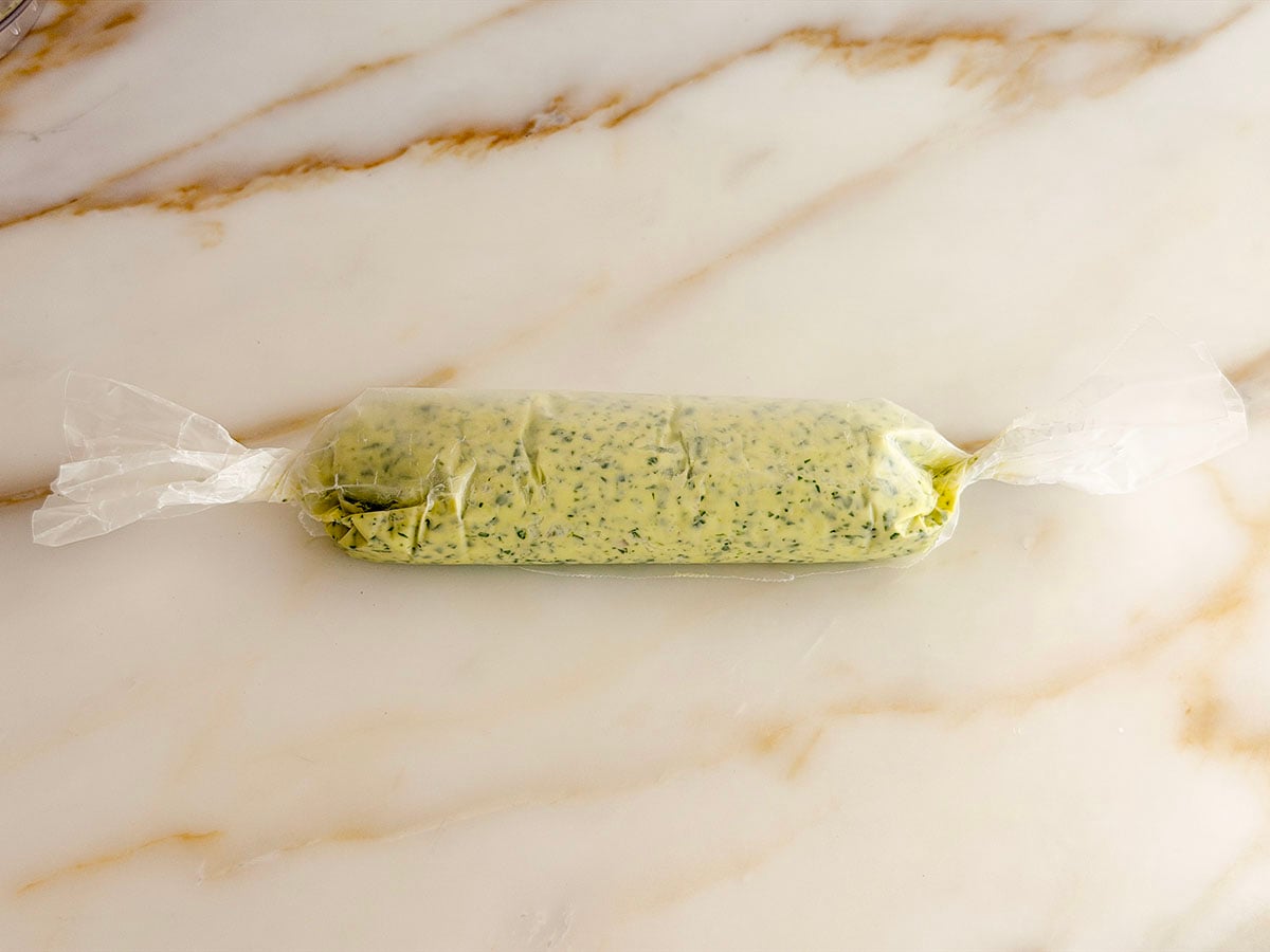 Compound butter rolled up into a log in wax paper with twisted ends