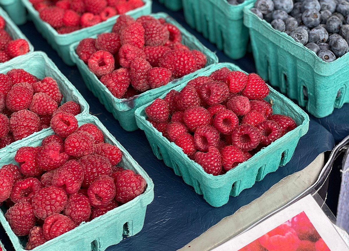 Raspberries in green pint containers at the market