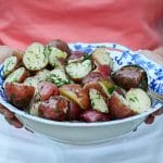 New potatoes in a blue and white bowl dusted with green dill