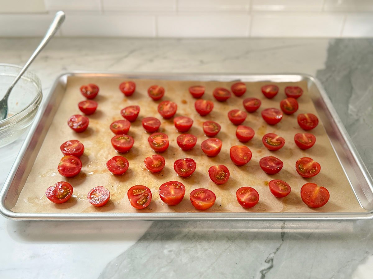Cherry tomatoes on a baking sheet with parchment paper