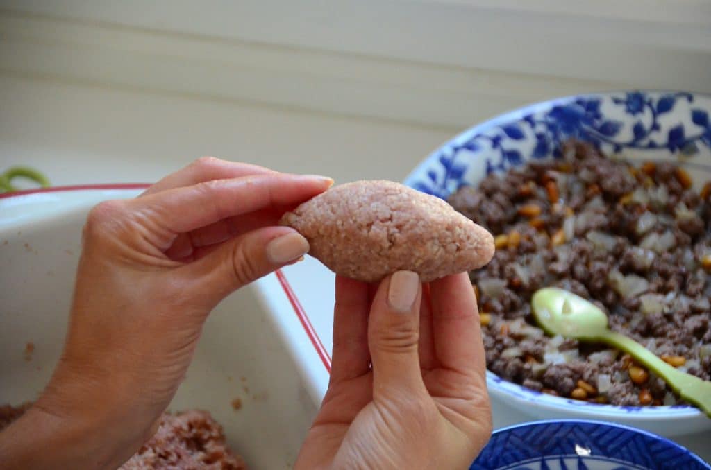 Arras kibbeh balls held in two hands while being shaped Maureen Abood