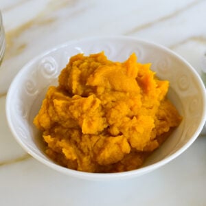 Pumpkin puree in a white bowl on the counter