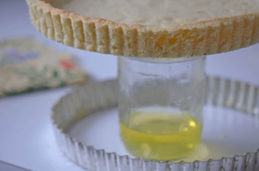 a baked removable bottom tart crust pan over a jar