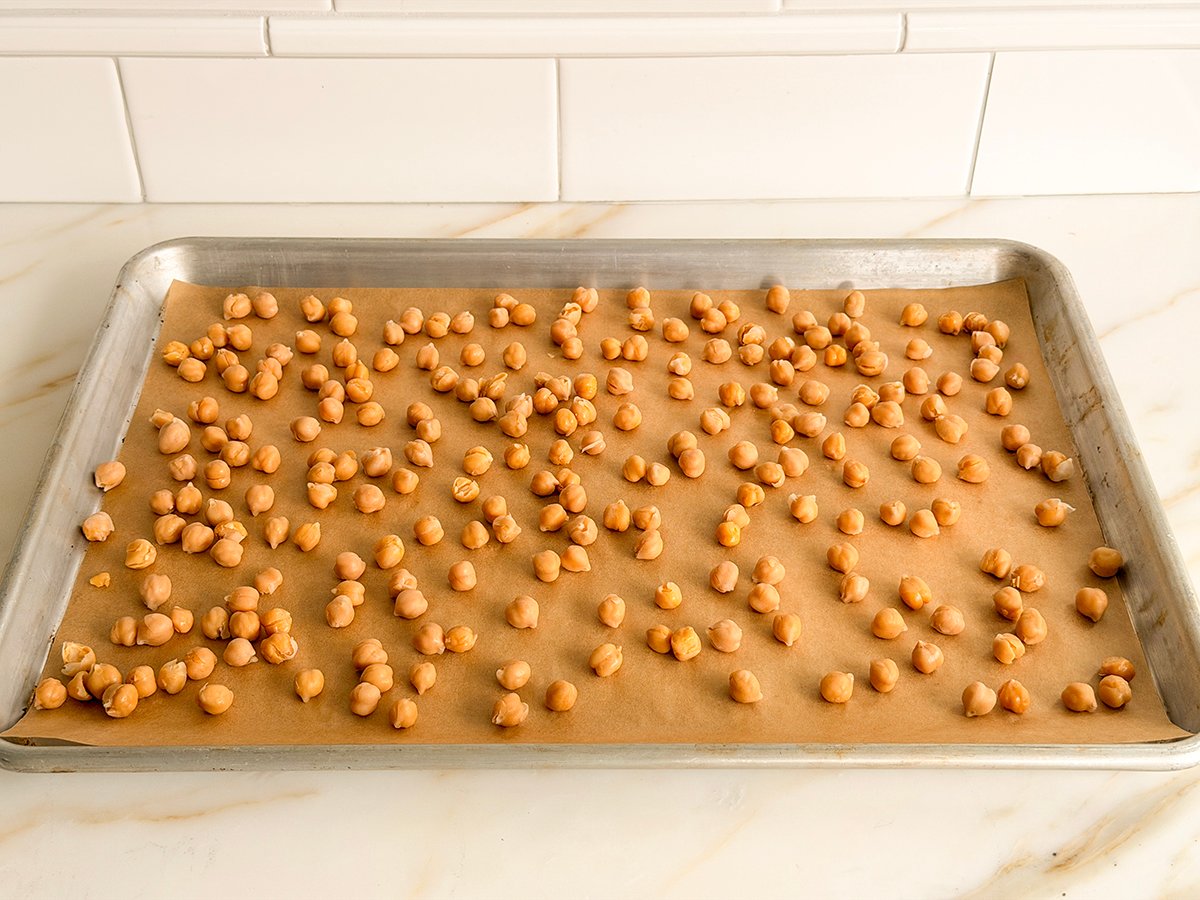 chickpeas on a parchment lined sheet before roasting