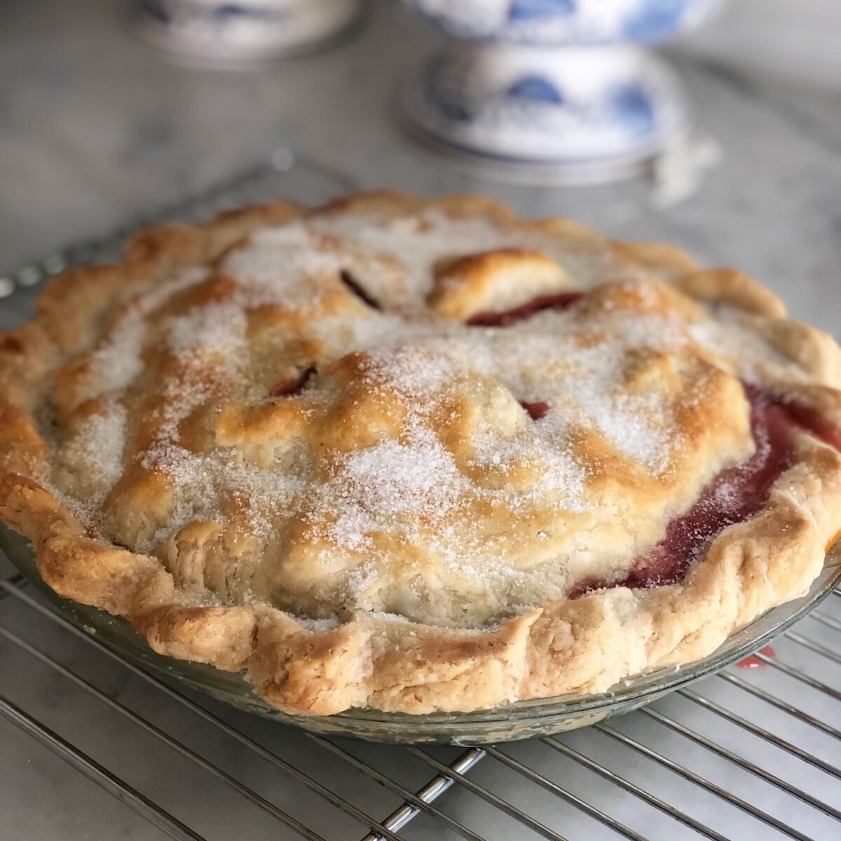 Strawberry rhubarb pie on a wire rack