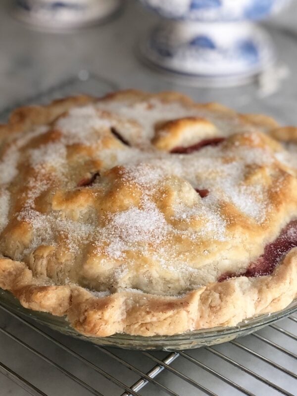 Strawberry rhubarb pie on a wire rack