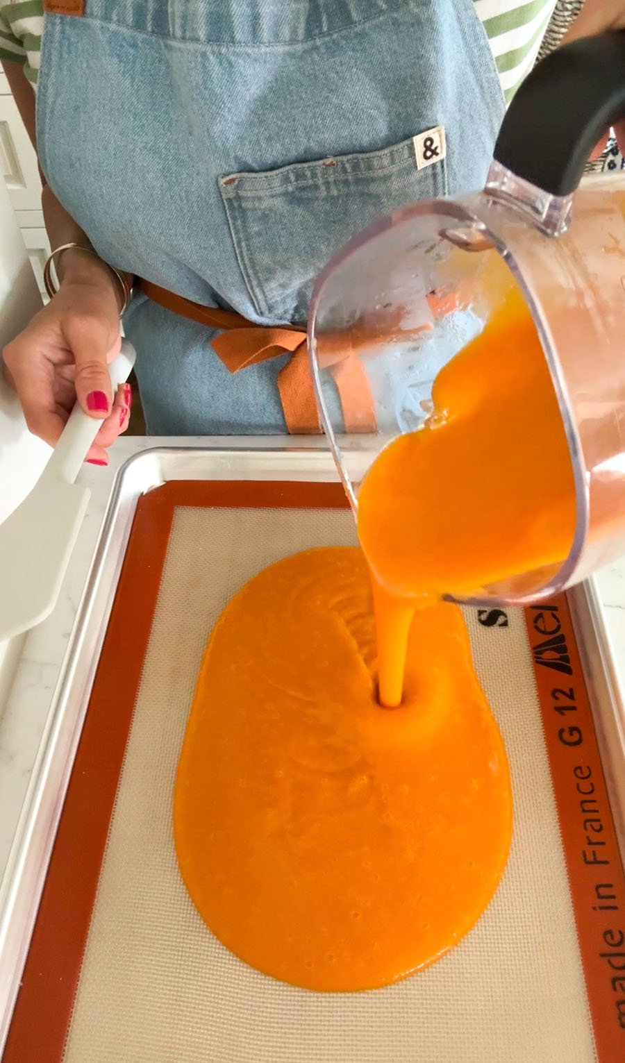apricot puree poured from a blender onto a silpat