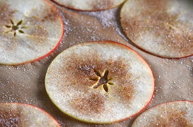 Apple slices with cinnamon sugar on a sheet pan