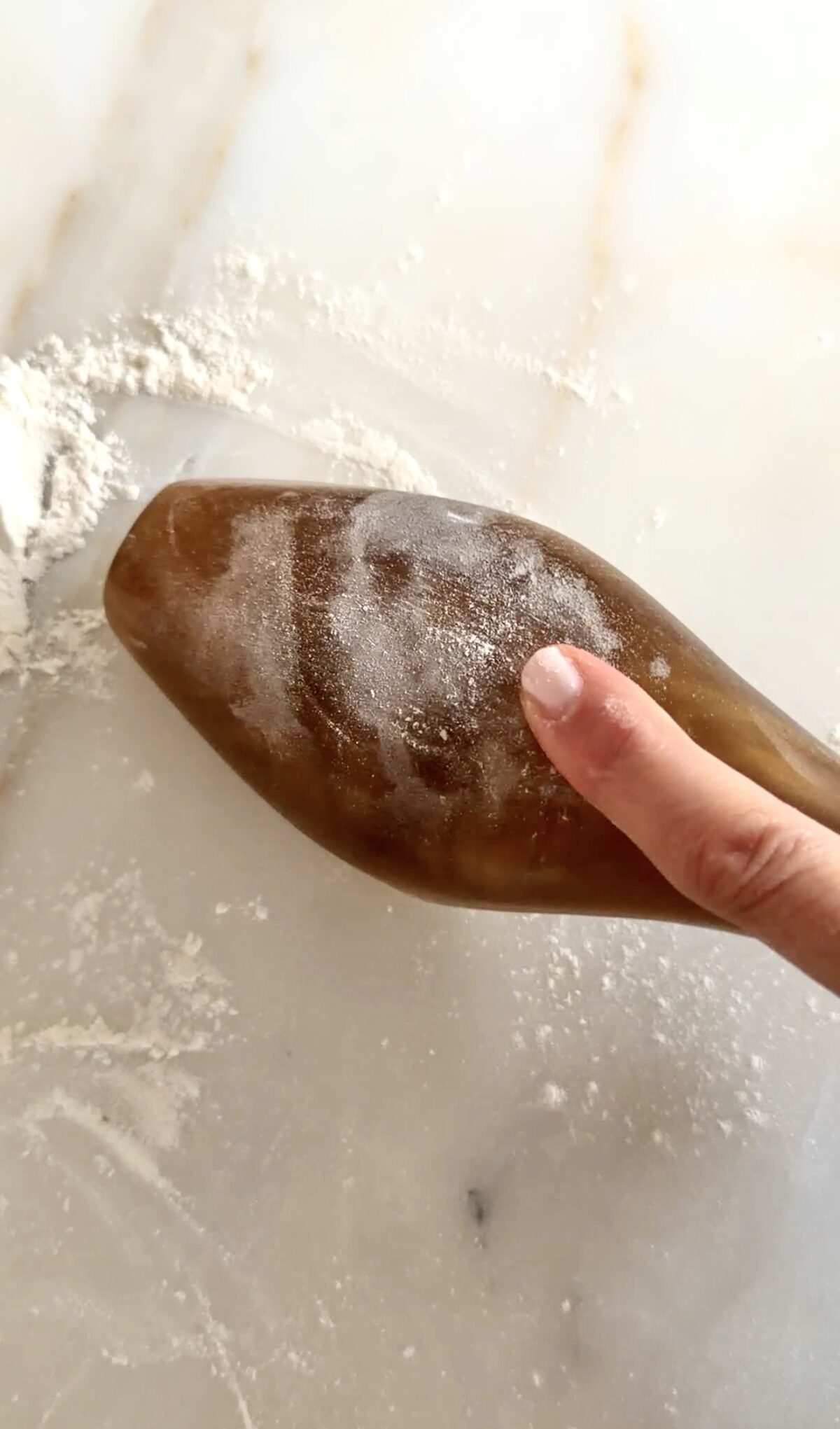 mamoul mold overturned on the counter with a finger on it