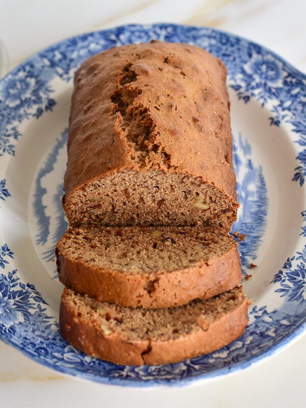 Loaf of date nut bread sliced on a platter