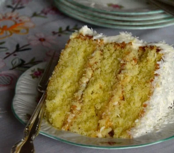 Triple layer coconut cake slice with a fork