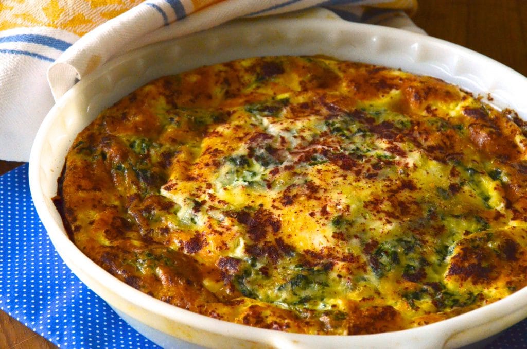 A baked crustless quiche with spinach and feta.