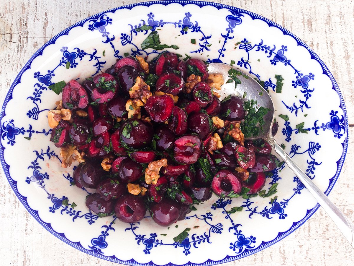 Cherry salad in a blue and white oval bowl