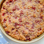 raspberry crumb cake in a round pan