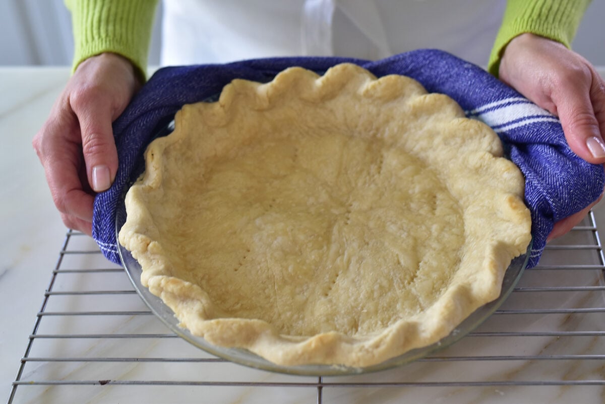 par baked pie crust with blue towel