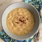 Avgolemono soup in a blue bowl