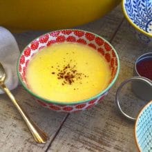 Avgolemono soup in a pink and white bowl