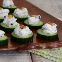 Cucumber bites with Labneh and Olives, on a copper platter