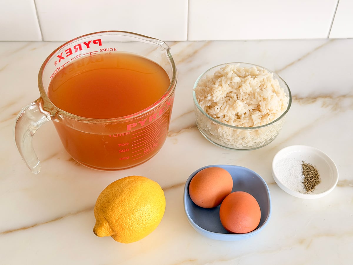 Ingredients for avgolemono soup on a marble countertop