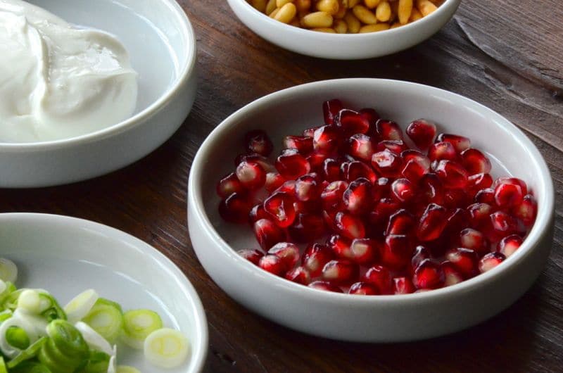 Garnish of pomegranate seeds in a white dish for Lebanese Fatteh