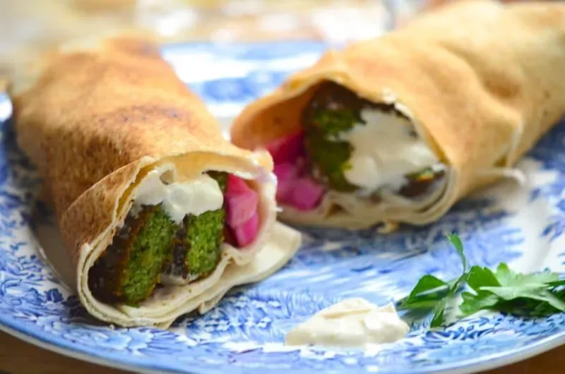 Fresh Herb Falafel Wrap cut in half on a blue plate