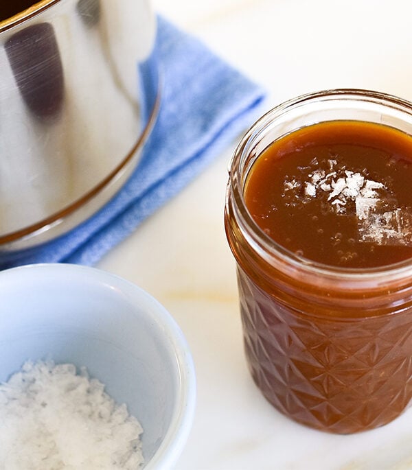 homemade caramel sauce in a jar with flakey salt on top