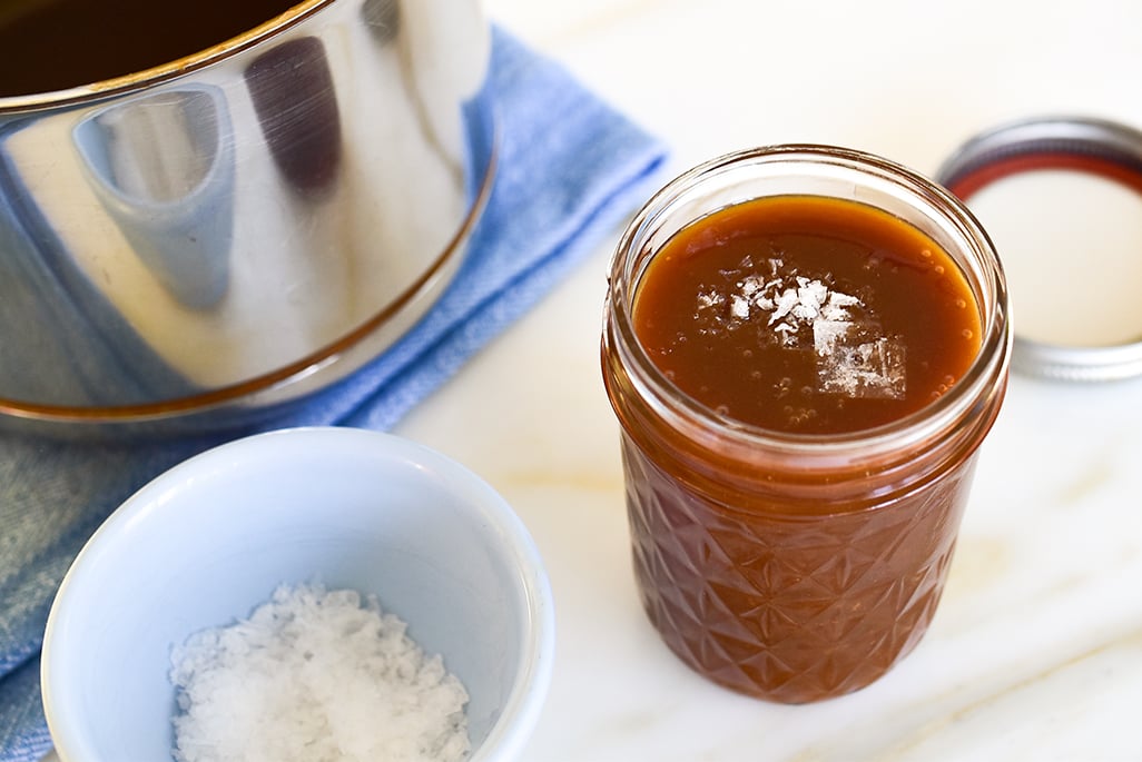 homemade caramel sauce in a jar with flakey salt on top