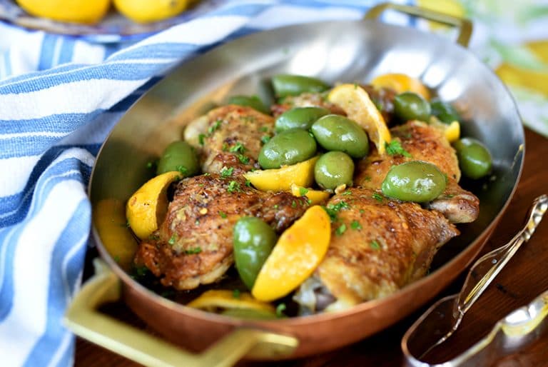 Chicken with lemon and olives in a copper baking dish