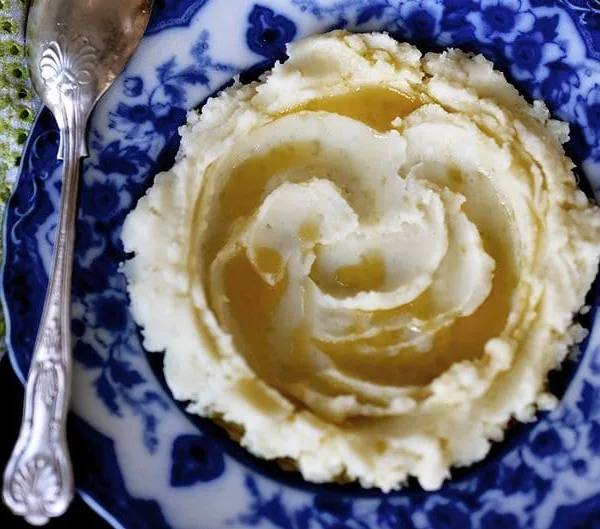 Mashed Potatoes with Olive Oil swirled on a blue plate